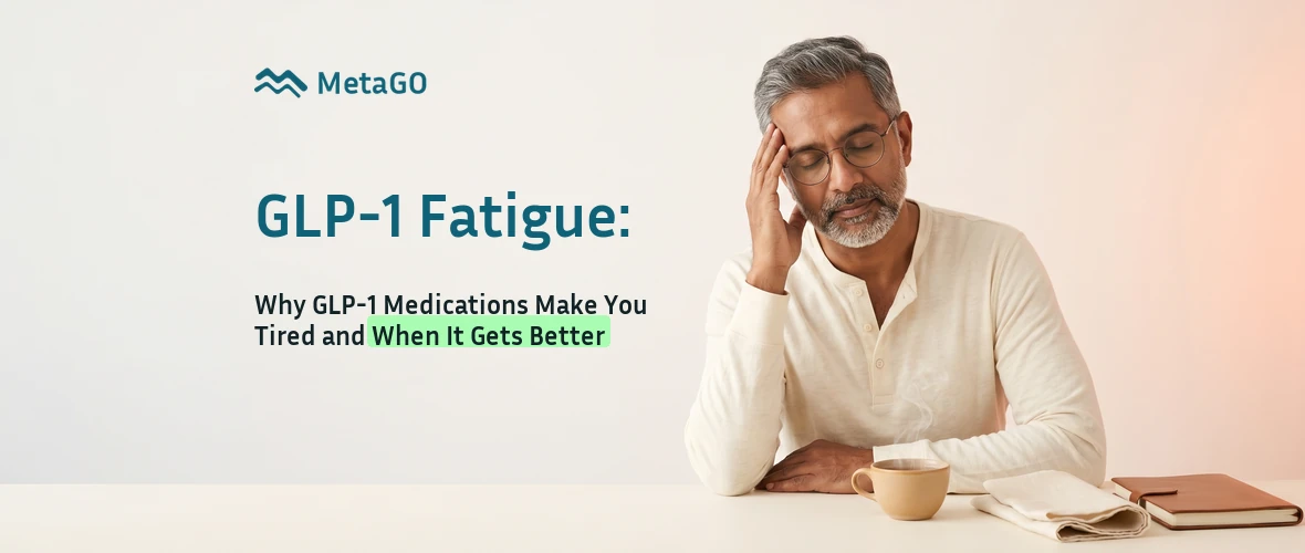 Indian man in his 50s with salt-and-pepper hair and glasses managing GLP-1 medication fatigue with calm reflection